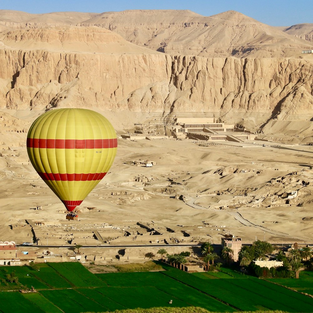 a hot air balloon flying over a town