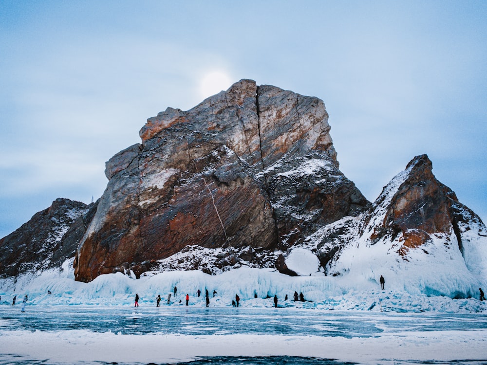 a group of people standing on a snowy mountain