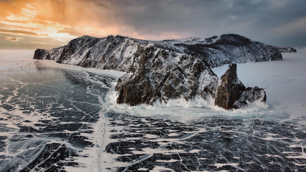 a snowy landscape with a rocky mountain