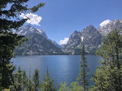 A lake surrounded by mountains, evoking the scenic backdrop visible from the Mural Room's picture windows