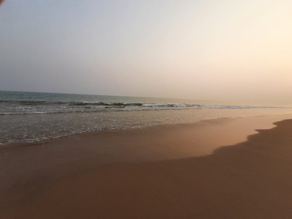 a sandy beach with waves