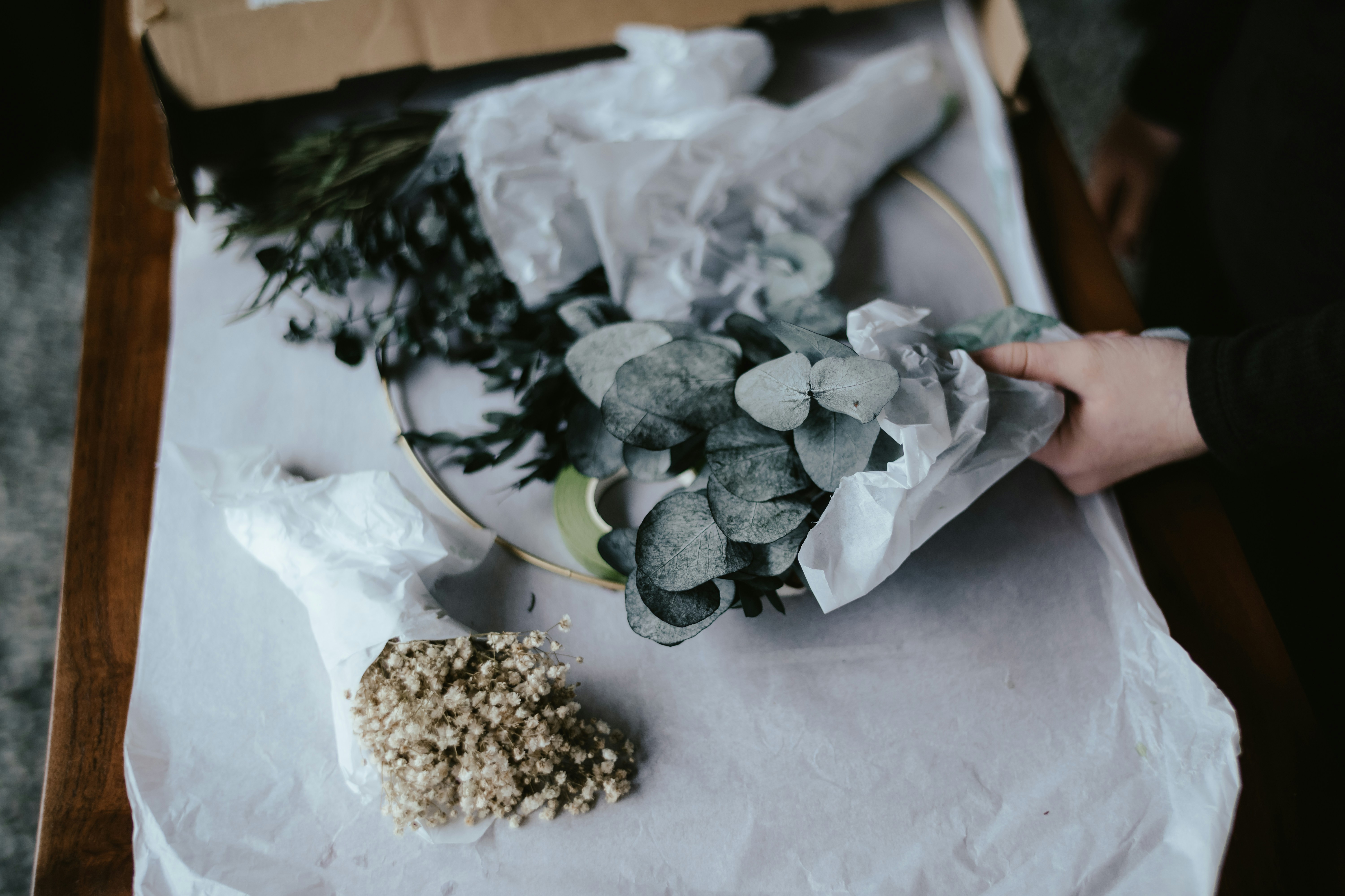 a hand holding a bag of marijuana