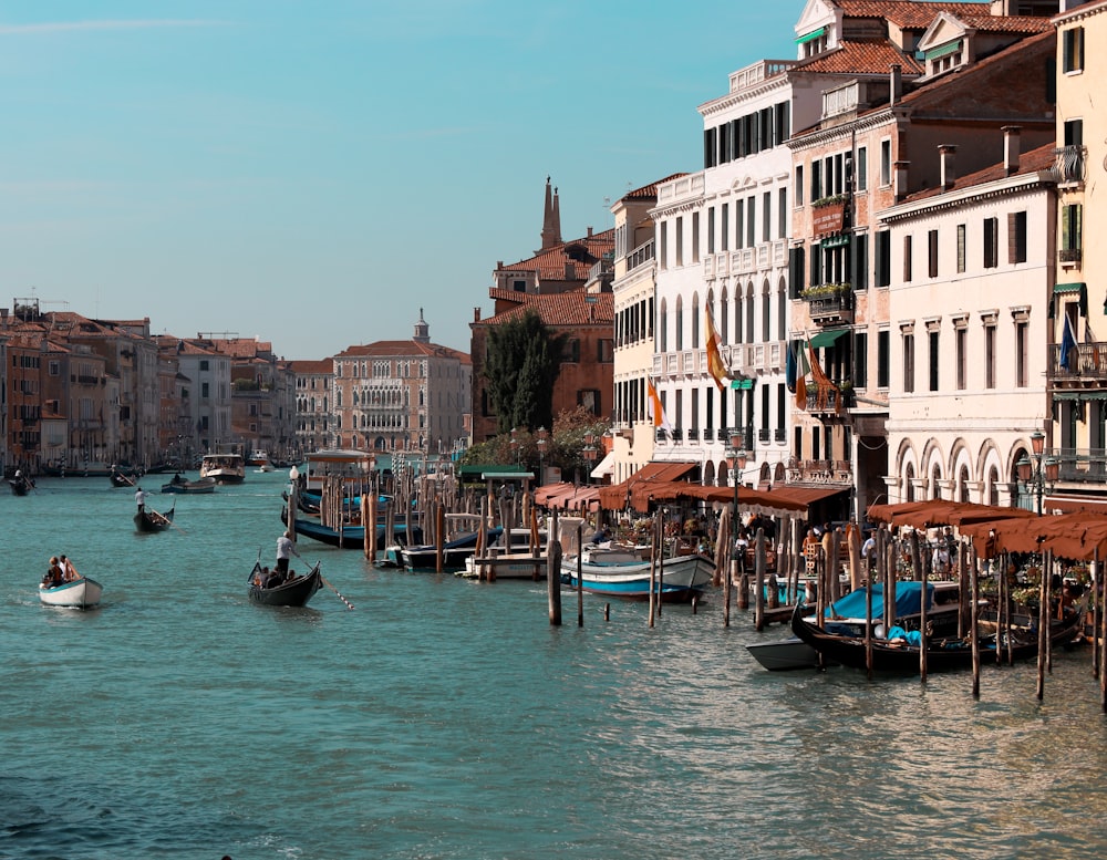 a body of water with boats in it and buildings around it with Grand Canal in the background