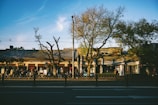 A calm urban street scene with people walking and buildings.