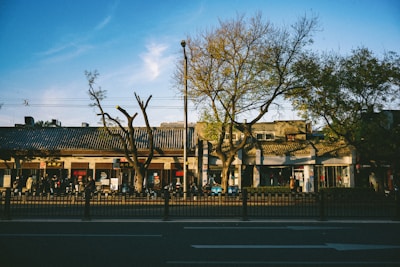 A calm urban street scene with people walking and buildings.