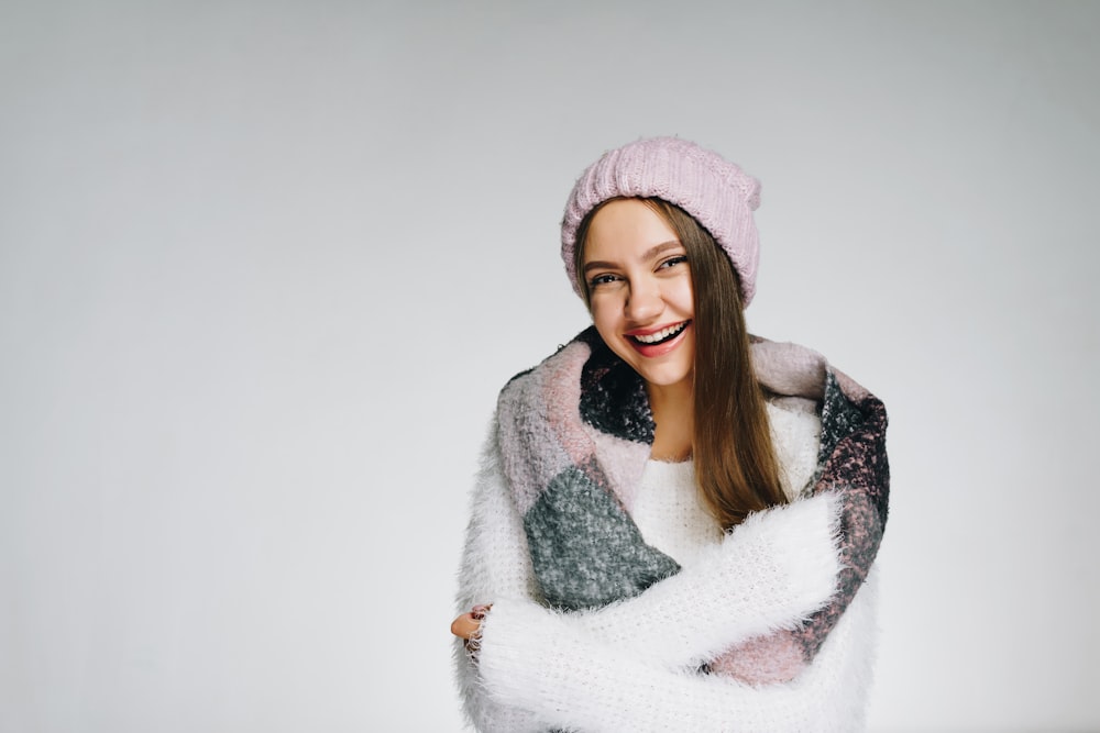 a woman wearing a pink beanie