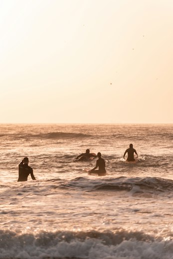 Surfers in the lineup at sunset near Taghazout, Morocco