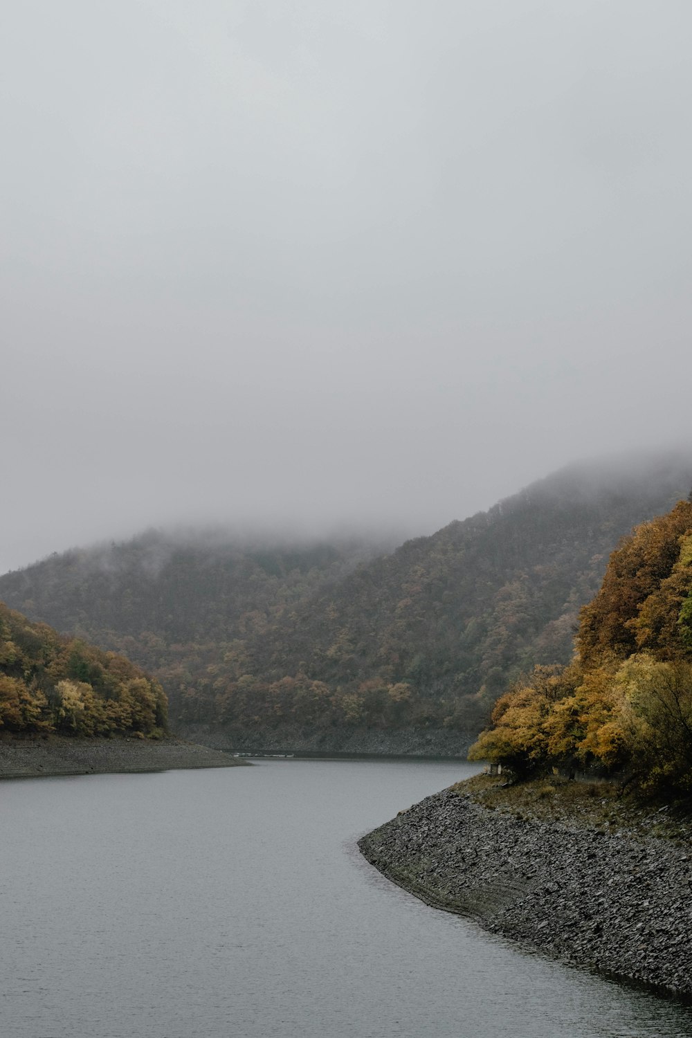 a body of water with hills in the back