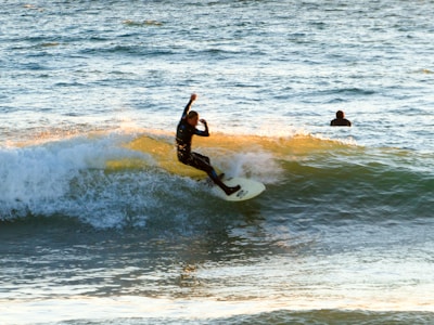 A surfer riding a wave at a beautiful Bali beach.
