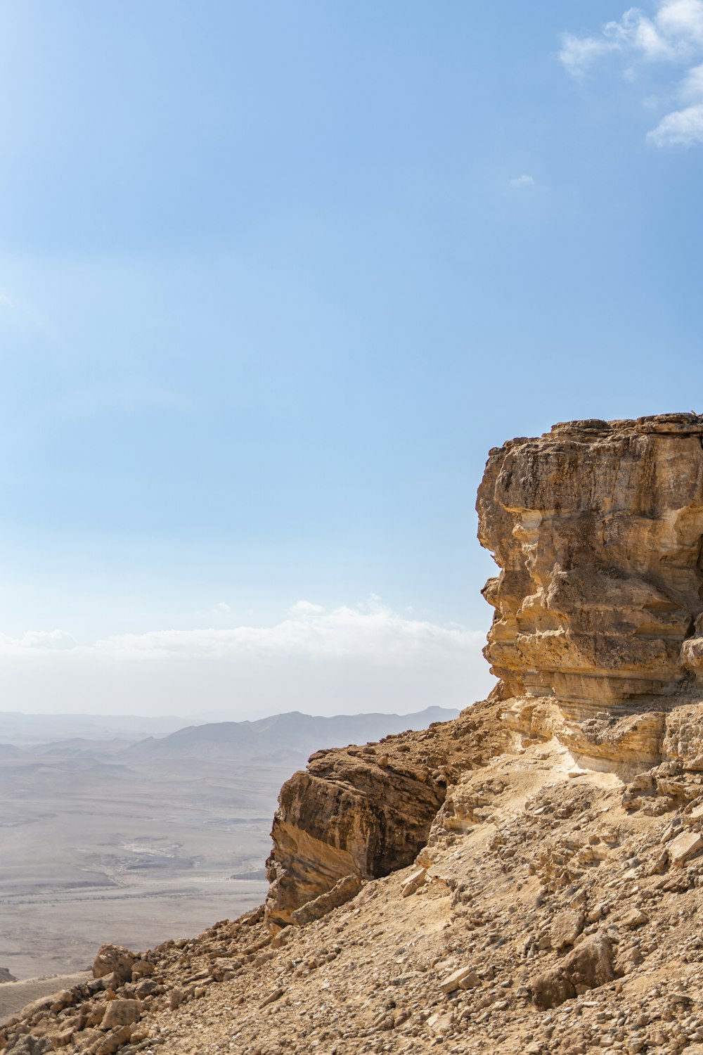 a rocky cliff overlooking a body of water