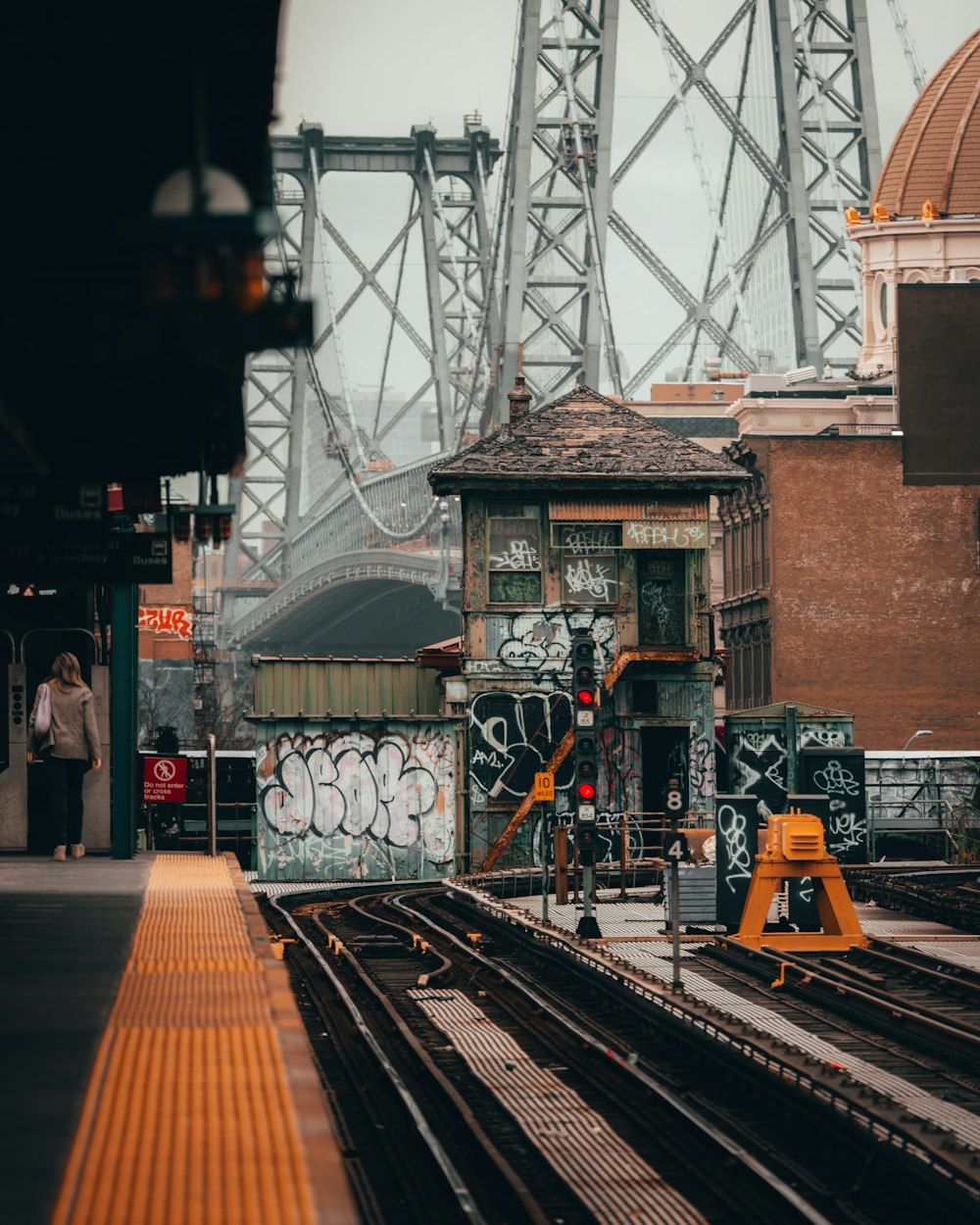 a person standing next to a train station