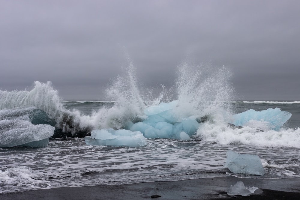 a large wave crashing into a beach