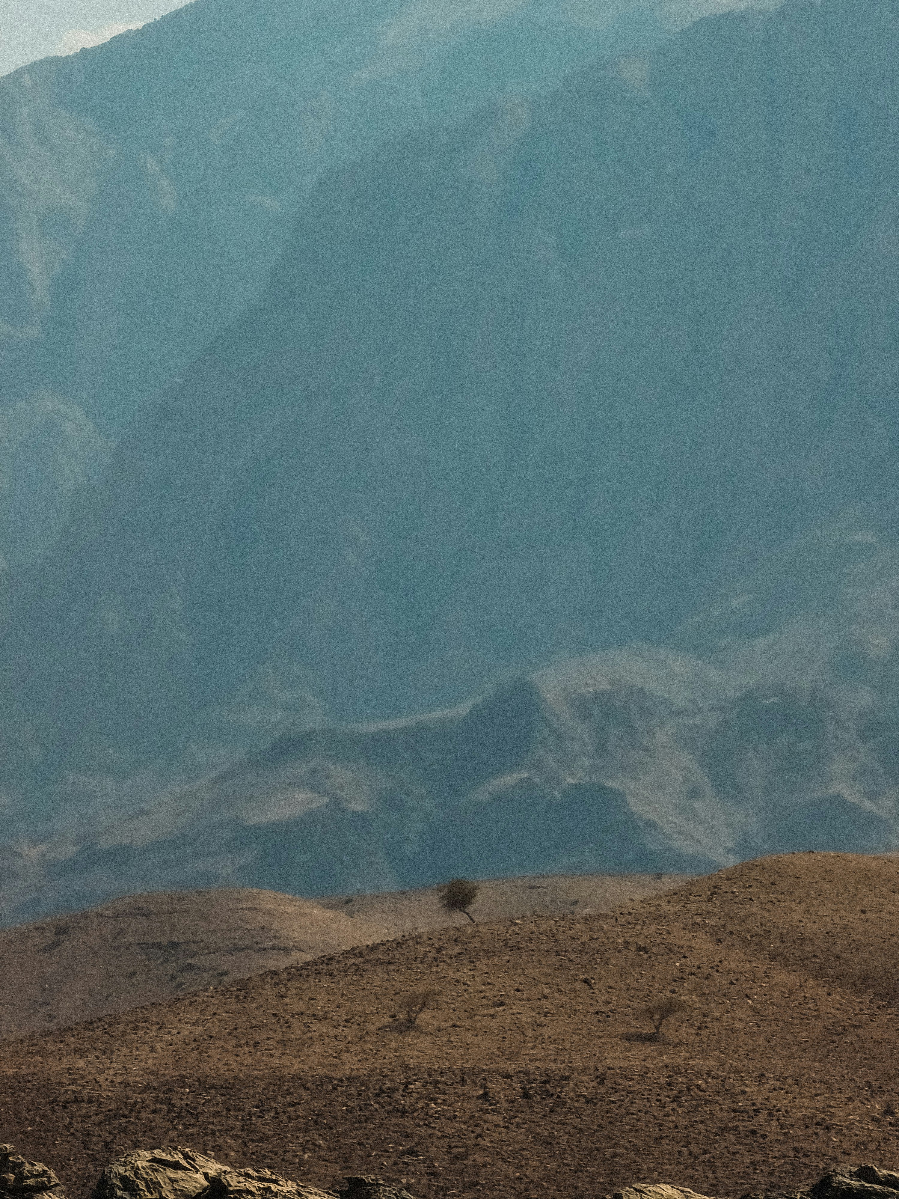 a large mountain with a valley below