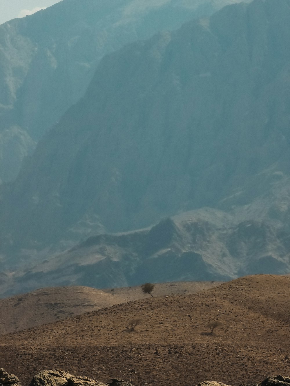 a large mountain with a valley below