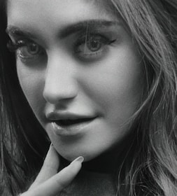 Black and white portrait of a person with expressive eyes and soft lighting.