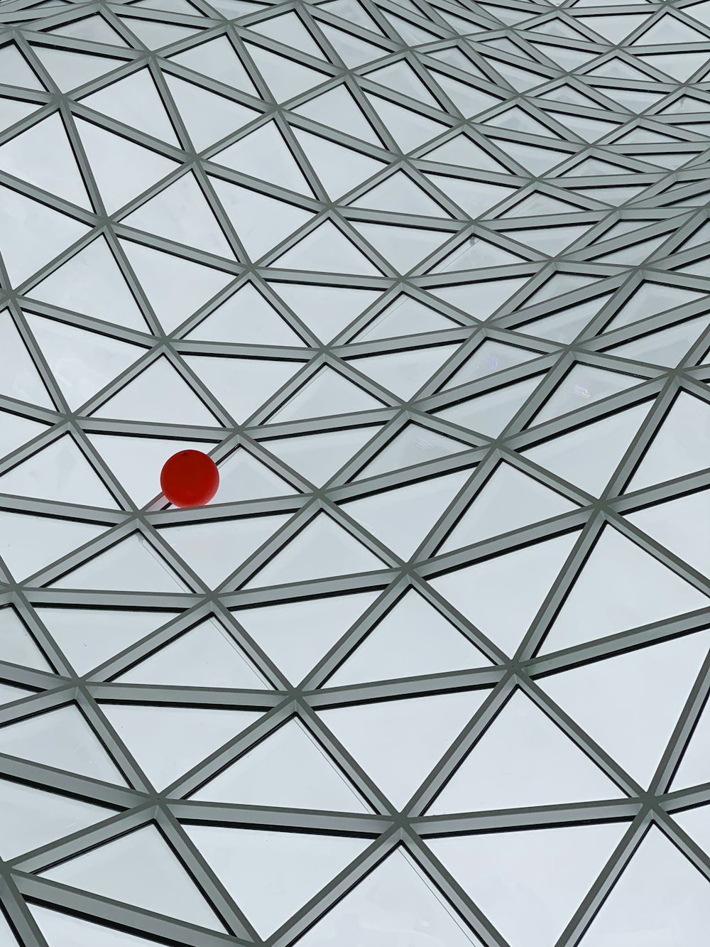 a red ball on a white ceiling