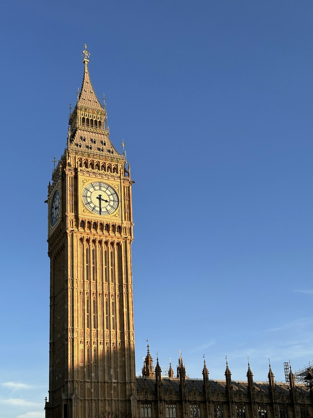 a large clock tower stands tall with Big Ben in the background