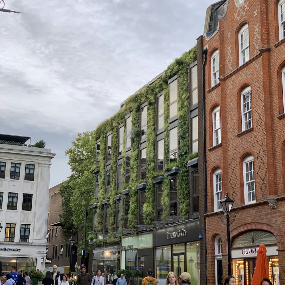 a group of people walking on a street between buildings