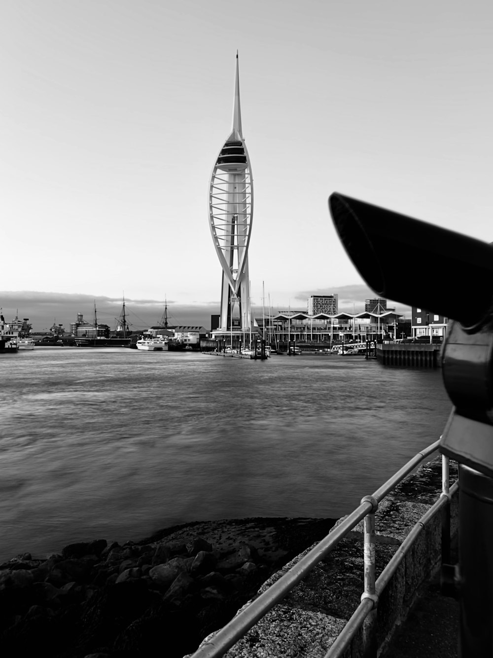 a large tower next to a body of water