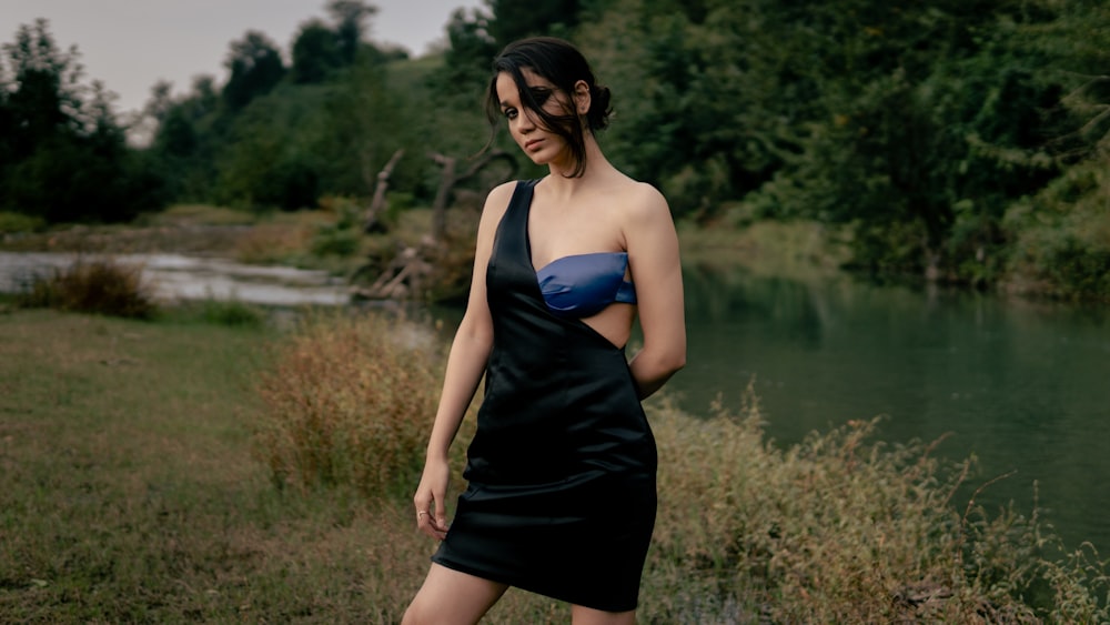 a woman standing in front of a lake