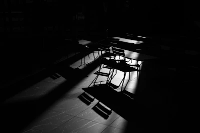 An overhead shot of a modular, geometric seating arrangement in a dimly lit room, highlighting contrast and form.