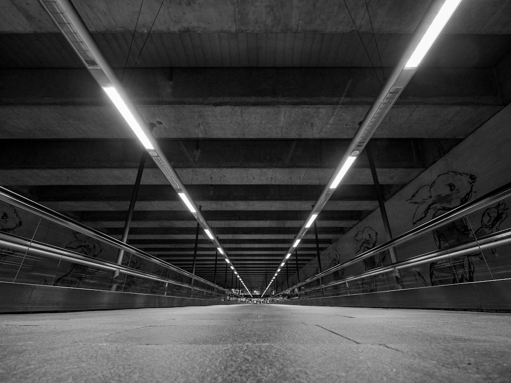 a black and white photo of a staircase with a railing and a light