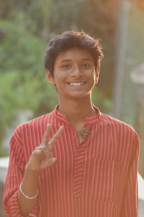 a woman smiling and holding her hands up