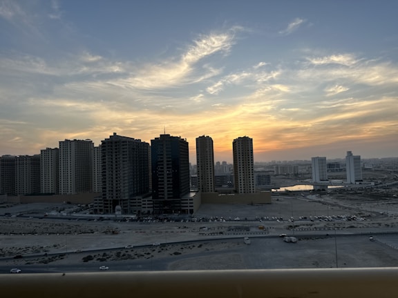 Exterior view of a high-rise building in Pune cityscape during sunset.