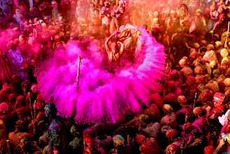 Crowd of happy runners celebrating with colorful powder in the air.
