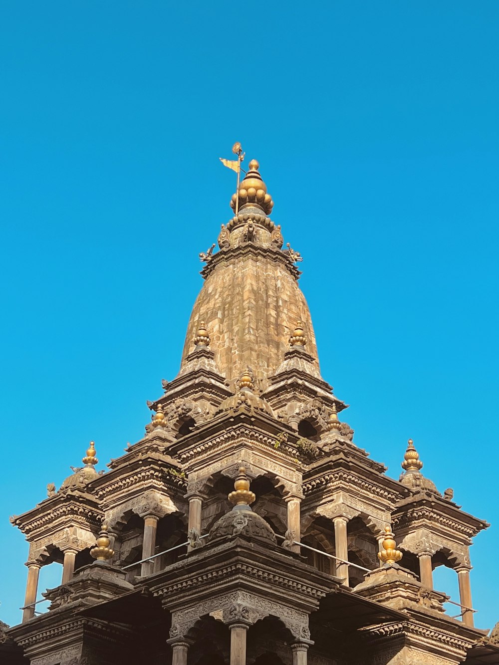 a building with a gold statue on top