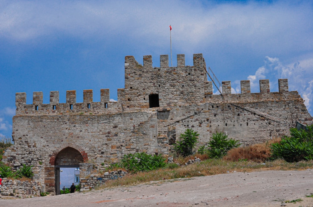 a stone castle with a flag on top