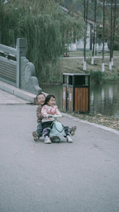 Happy children playing with ride-on battery cars in a sunny park.