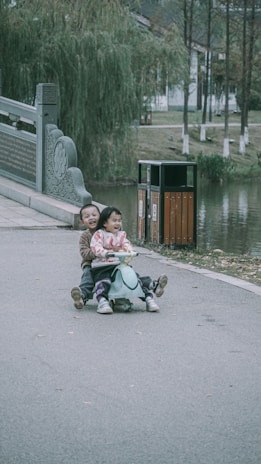 A group of children with special needs happily riding their adaptive tricycles together in a park.