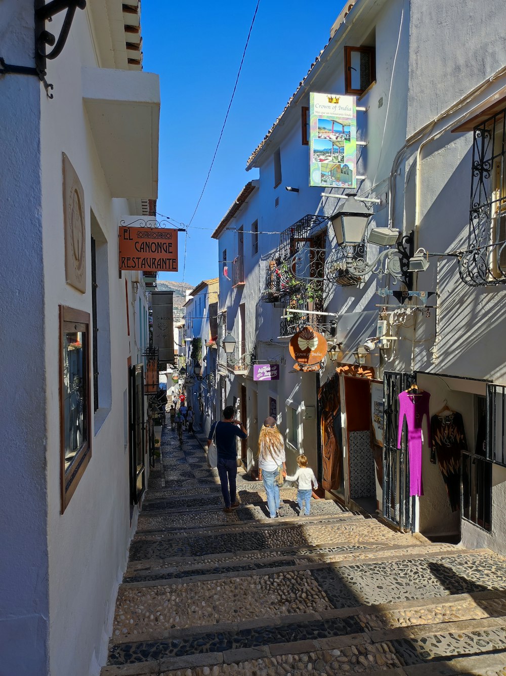 people walking down a narrow street