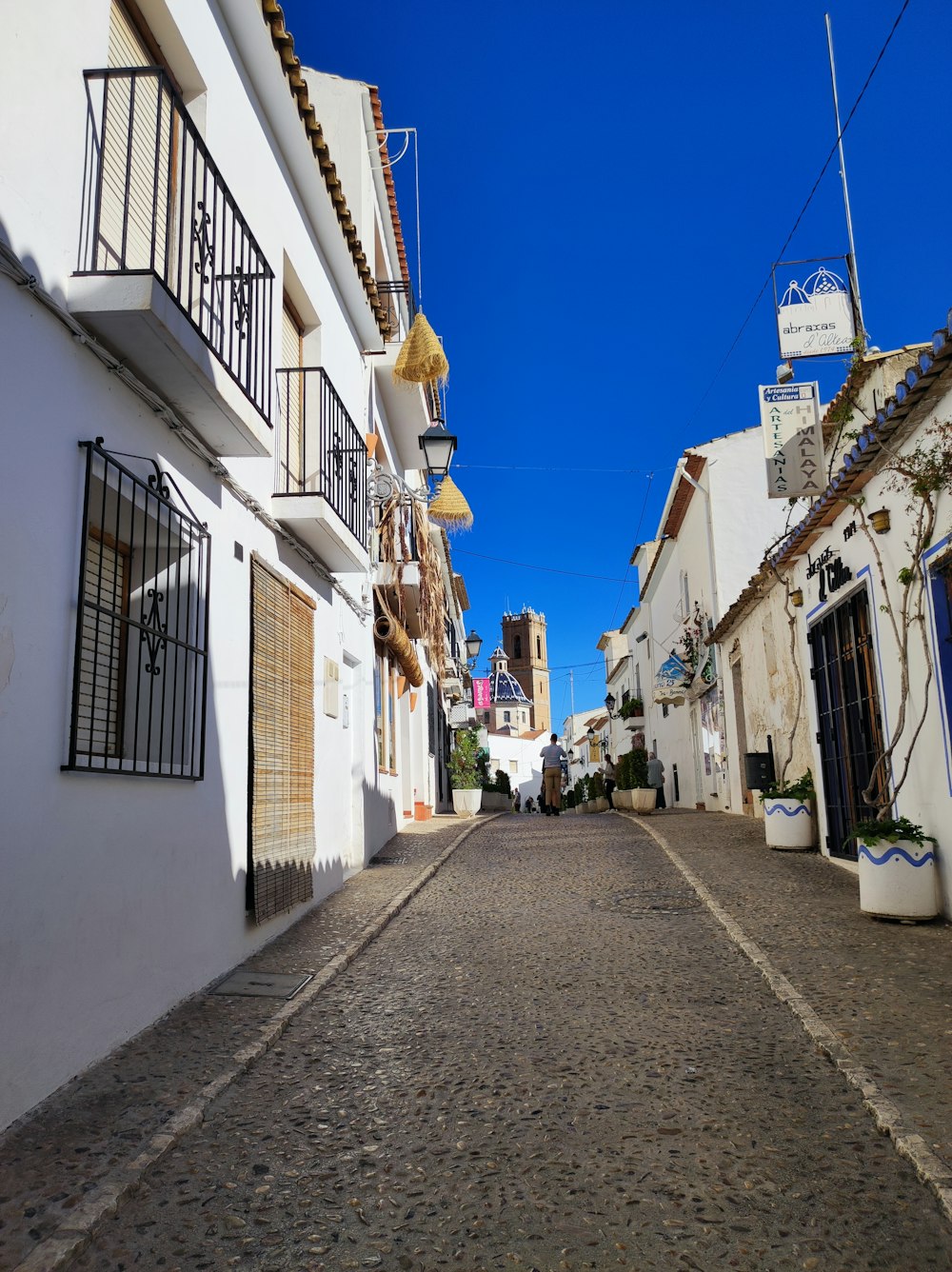 a cobblestone street with buildings on both sides