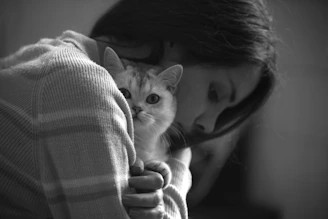 a person holding a cat