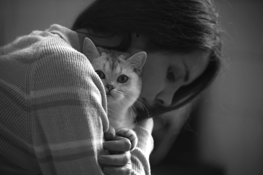 a person holding a cat