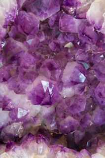 A pile of purple crystals sitting on top of a table