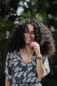 a person smiling with the hand on the face