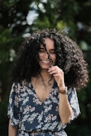 a person smiling with the hand on the face