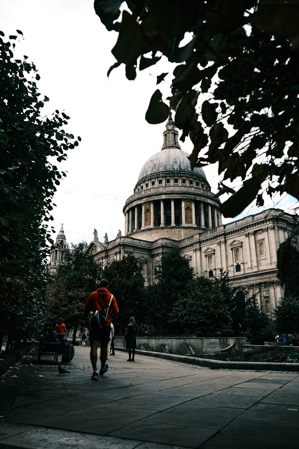 a person walking in front of a large building