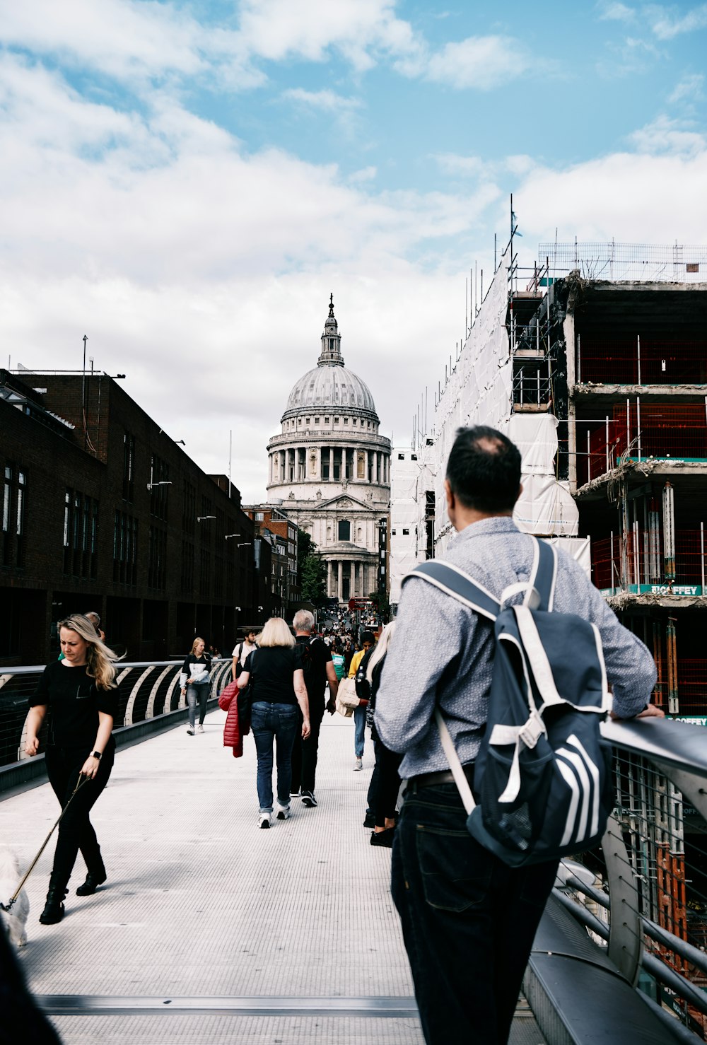 a group of people walking on a bridge