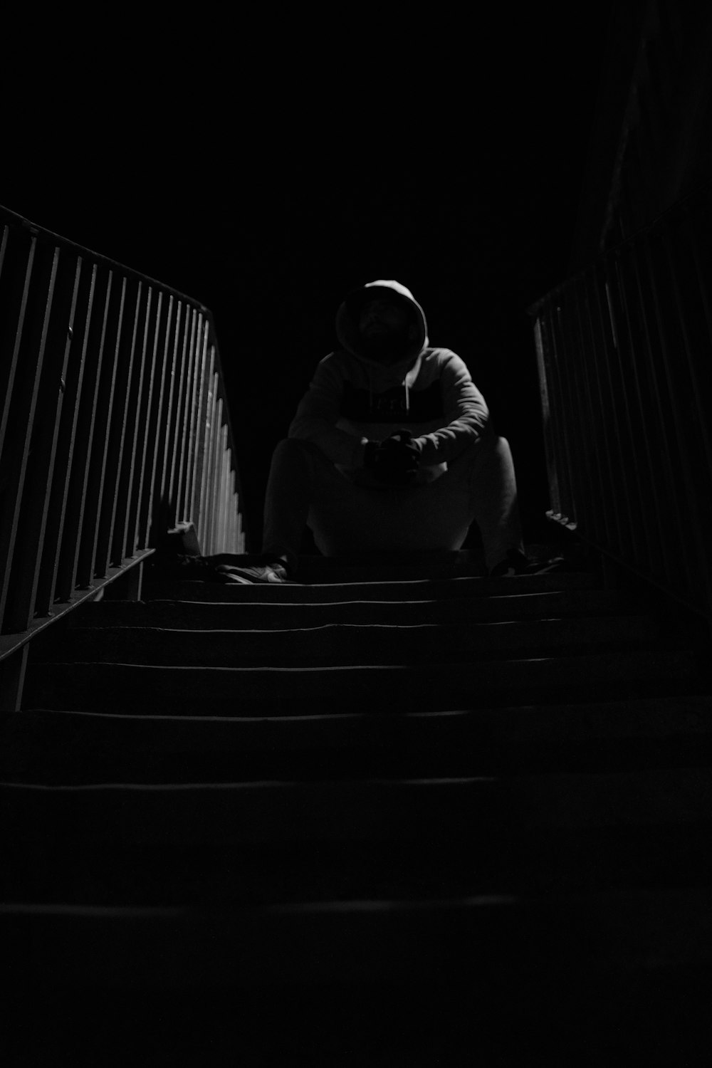 a statue of a person sitting on stairs