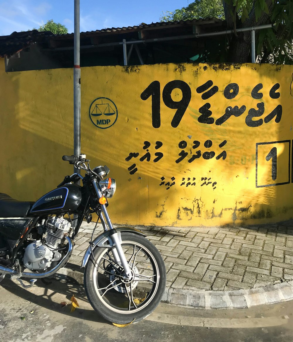 a motorcycle parked in front of a sign
