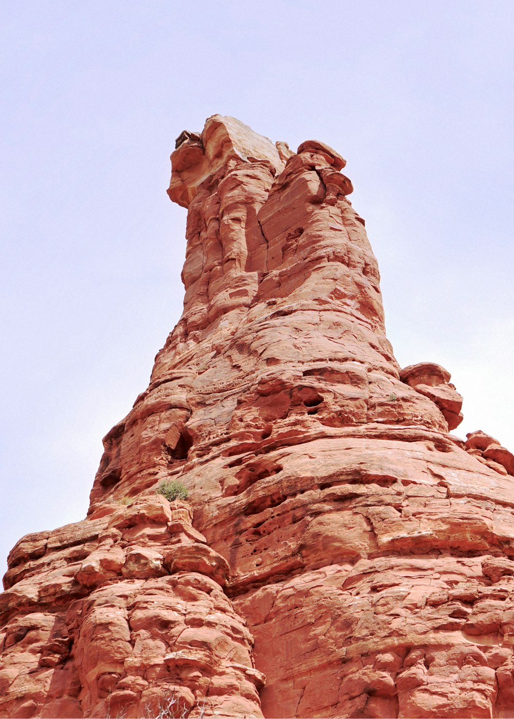a large rock formation with Bell Rock in the background