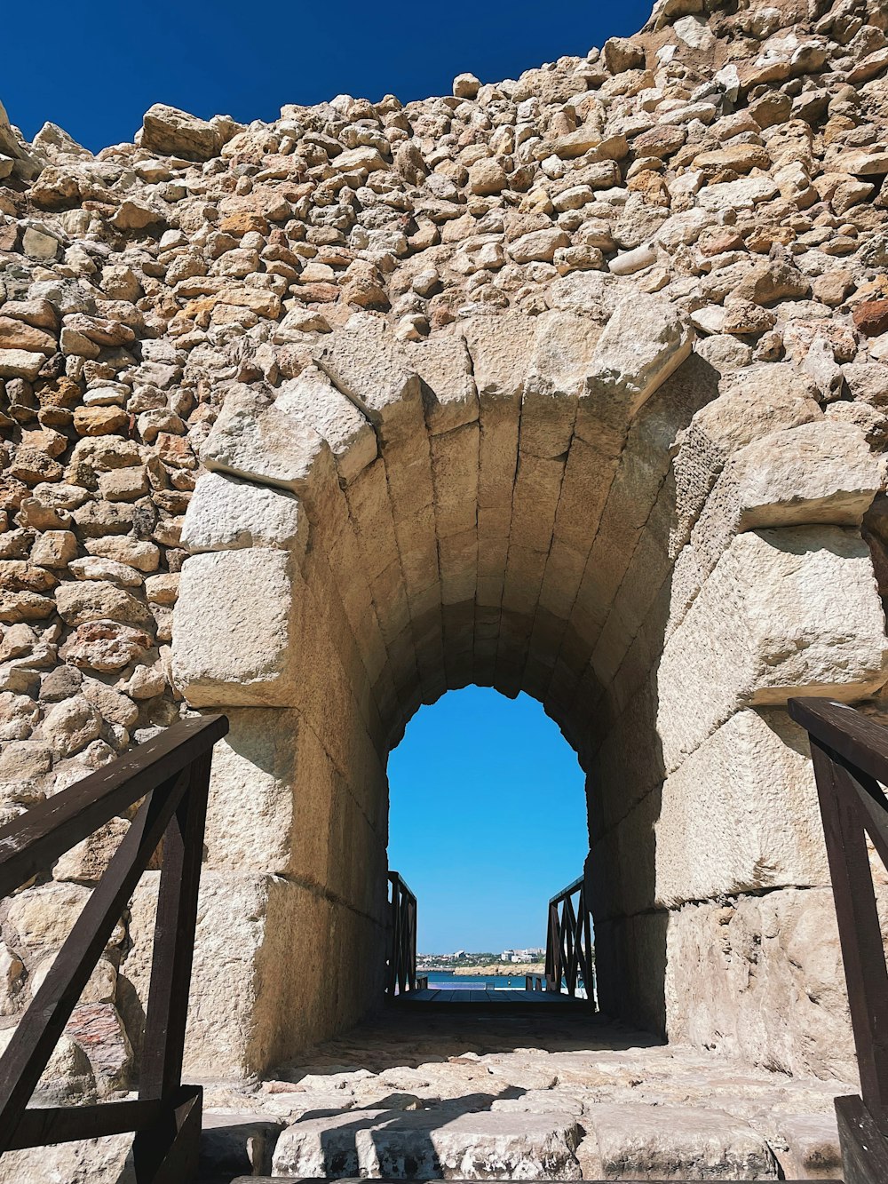 a stone archway with a railing