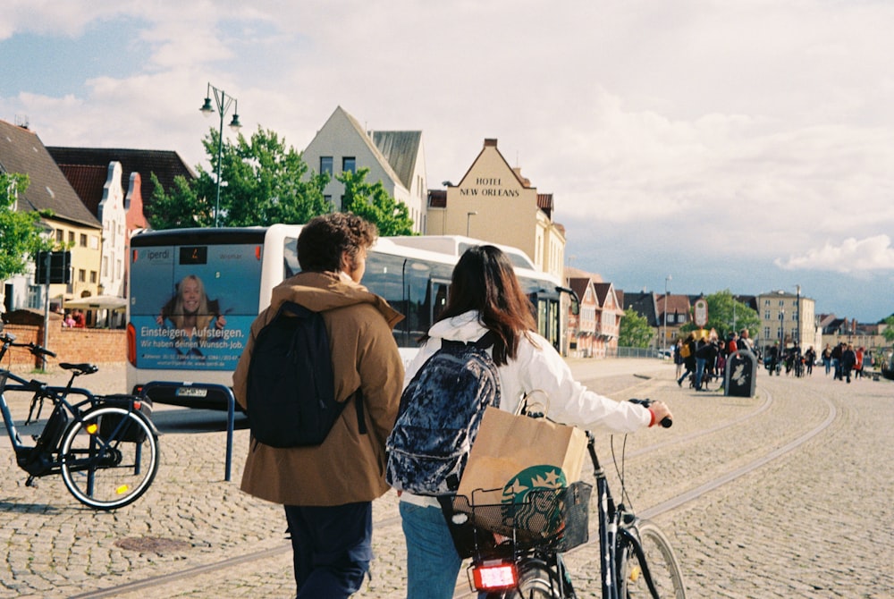 a man and woman looking at a poster on a wall