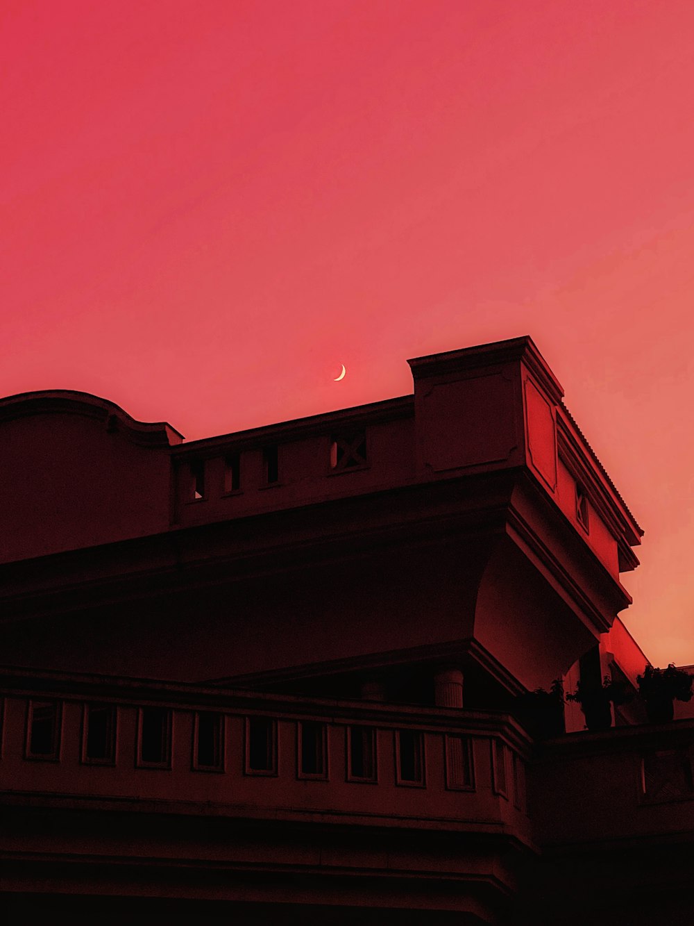 a building with a pink sky