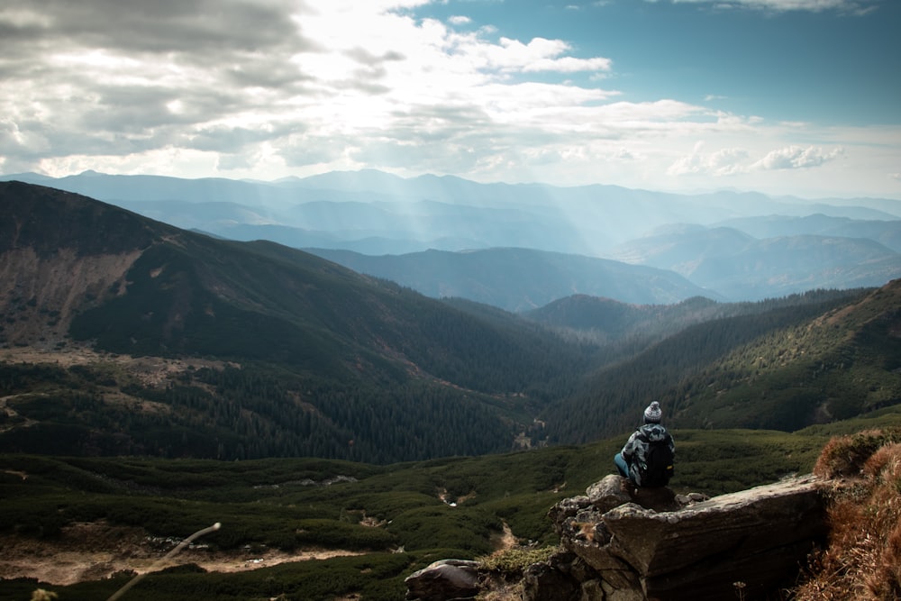 a person sitting on a rock