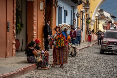 a group of people sitting on the sidewalk